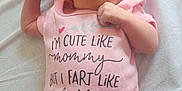 Aiyana is registered to the contest to win money with this photo: baby, infant, pink_clothing, hat, onesie, lying_down, blanket, newborn, cute, face, expression, child, soft_texture, light, resting, small_hands, baby_girl, humor, clothing_text, portrait