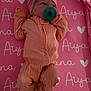 newborn, baby, pacifier, headband, flower, blanket, pink, peach, clothing, lying_down, infant, cute, soft, sleepwear, cozy, indoors, heart_pattern, textile, child, small