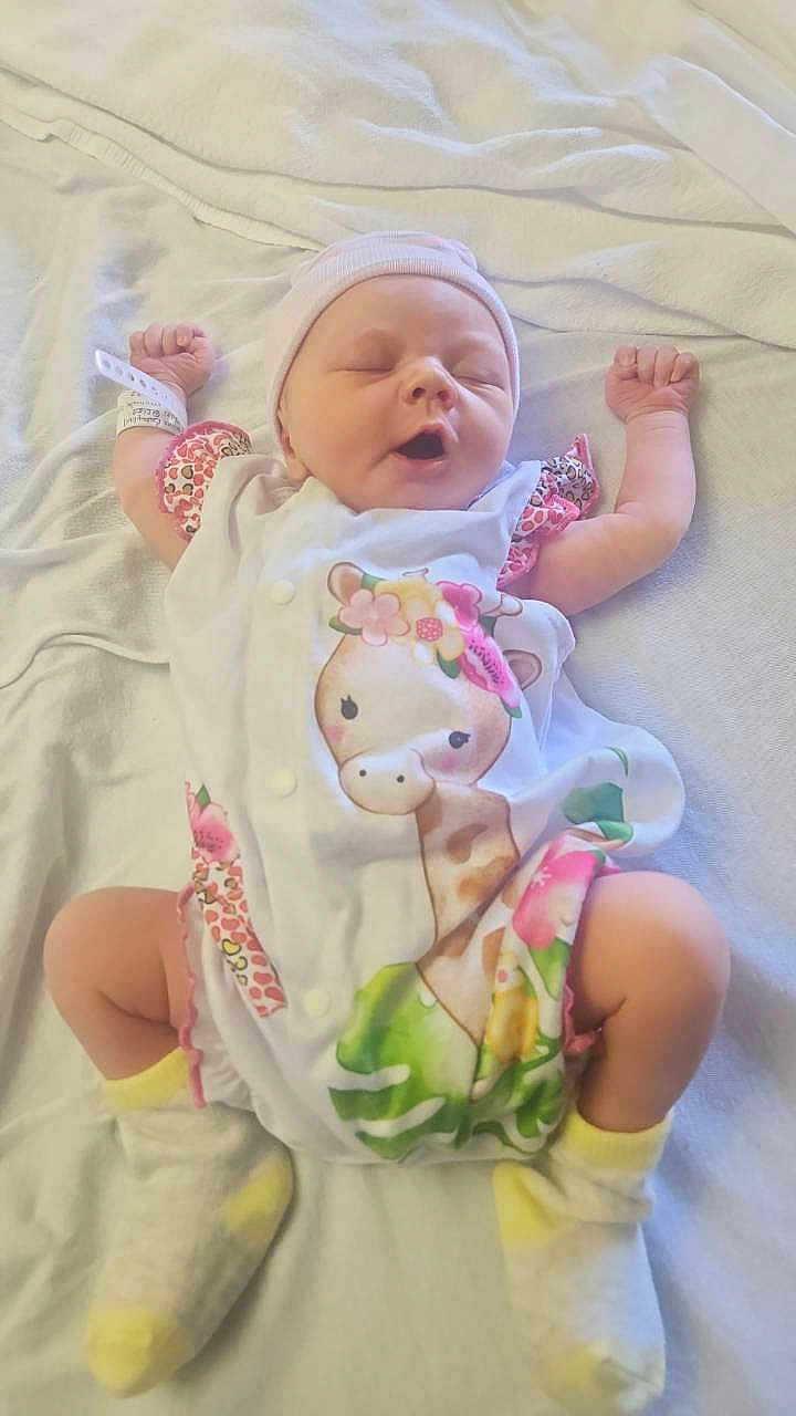 Aiyana is registered to the contest to win money with this photo: baby, infant, sleeping, blanket, hat, socks, hospital_bracelet, giraffe_print, onesie, cute, newborn, soft, lying_down, child, peaceful, adorable, indoors, clothing, portrait, resting