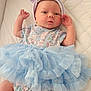 Aiyana is registered to the contest to win money with this photo: baby, infant, child, blue_tutu, headband, bow, floral_outfit, white_quilt, cute, lying_down, small_hands, pastel_colors, soft_fabric, newborn, portrait, indoor, comfortable, adorable, fashion, sleepwear