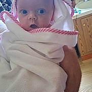 Aiyana is registered to the contest to win money with this photo: baby, bathroom, cabinet, child, curtain, expression, face, floor, hand, hooded_towel, indoor, person, pink, plumbing, sink, surprised, towel, white, window, wood