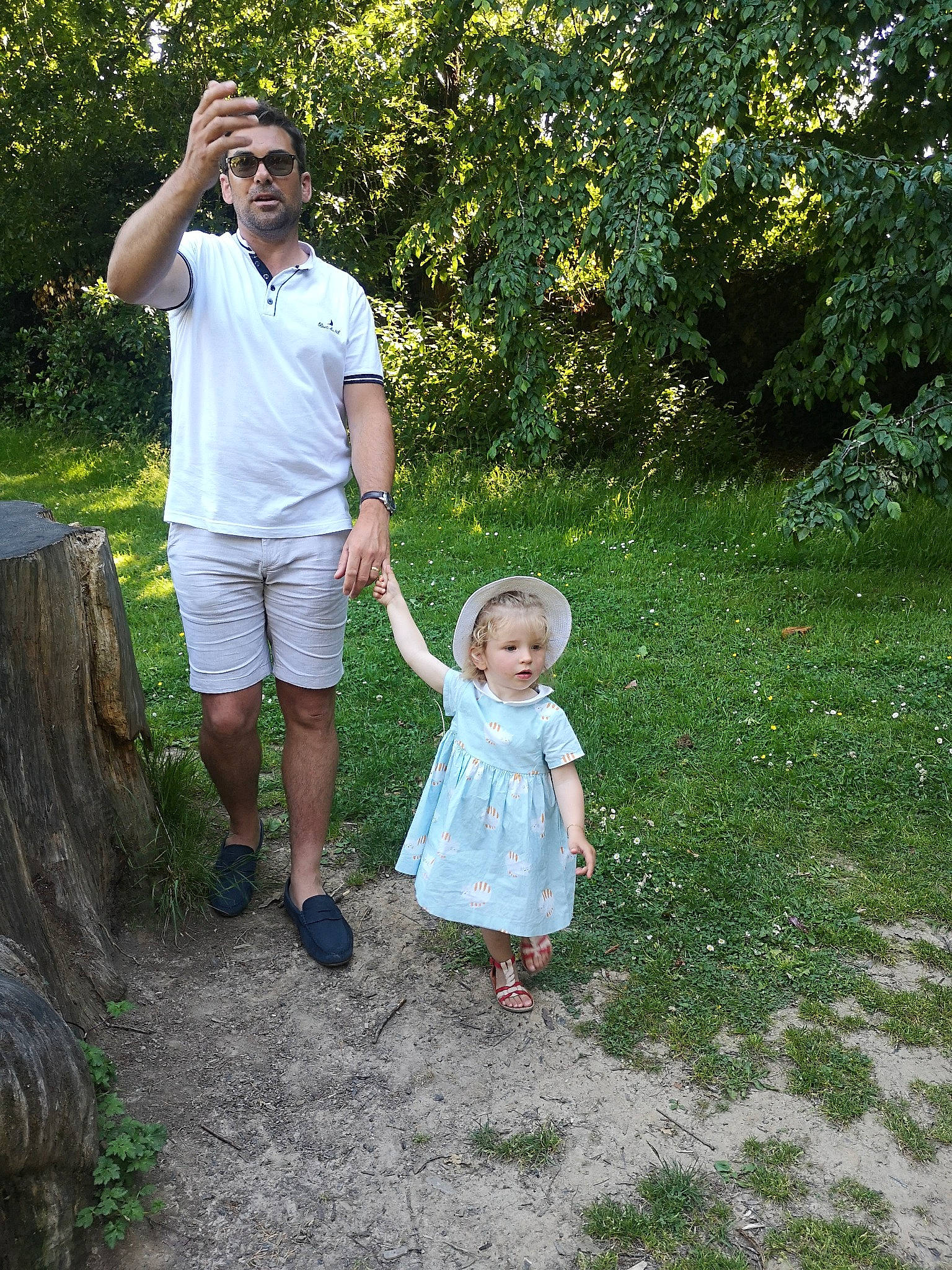 Nora participe au concours pour gagner de l'argent avec cette photo : baby_toddler_clothing, botany, dress, event, fun, garden, gesture, grass, grass_family, happy, head, landscape, lawn, leisure, people_in_nature, person, plant, recreation, toddler, tree