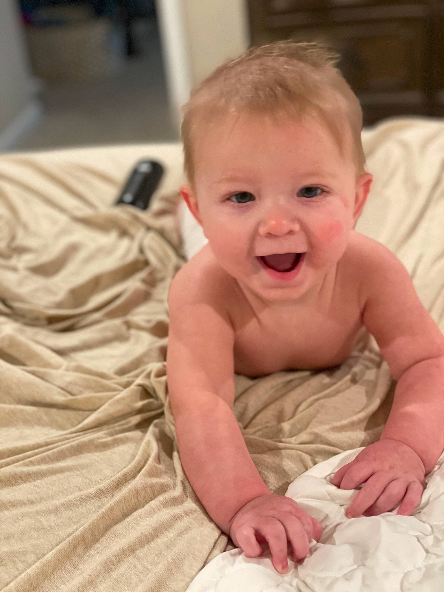 Tanner is registered to the contest to win money with this photo: baby, baby_toddler_clothing, cheek, child, chin, comfort, eye, face, finger, flooring, fun, happy, head, iris, linens, person, sitting, skin, sleeve, smile