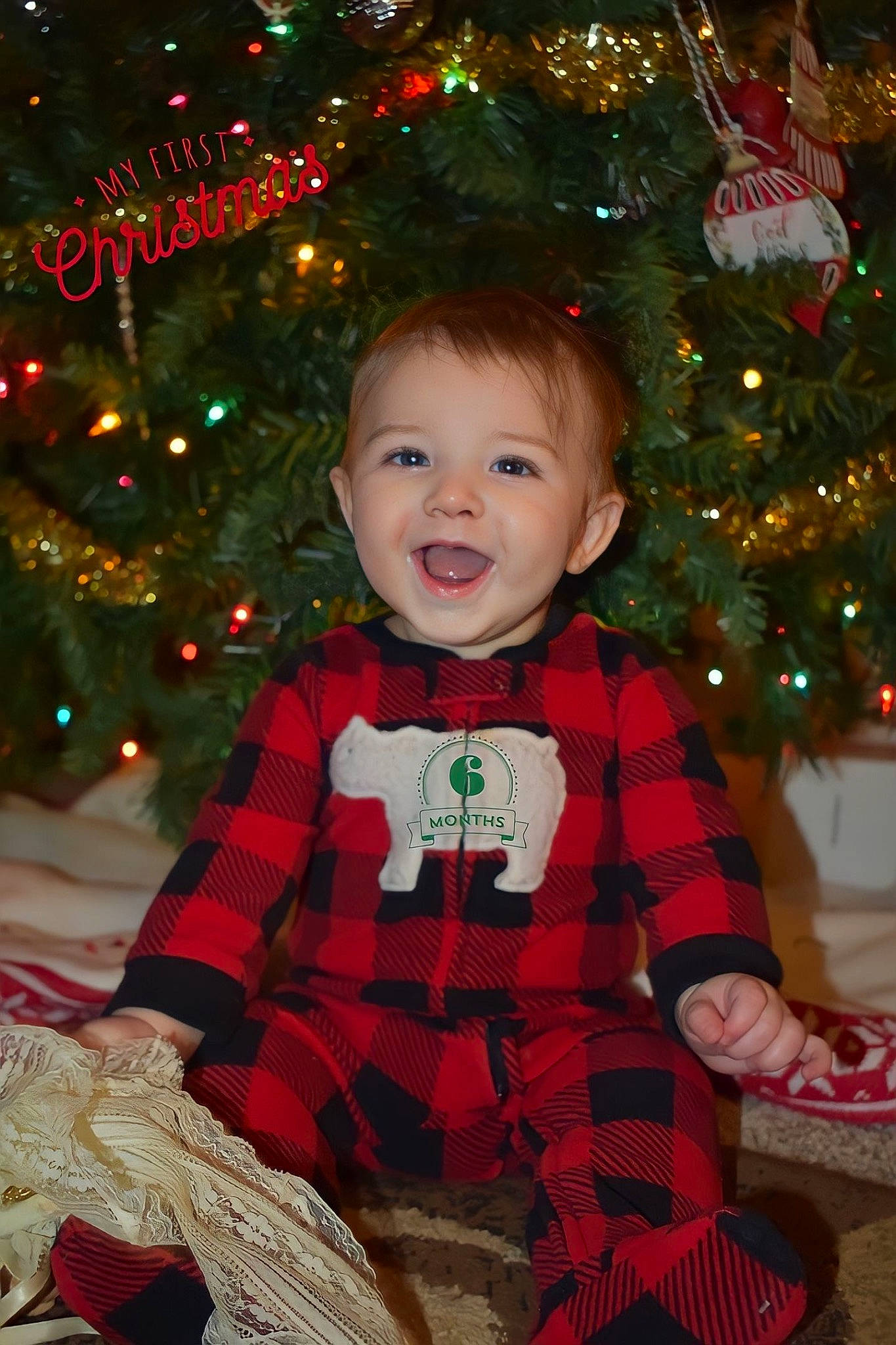 Tanner joined the competition — help win amazing prizes! baby_toddler_clothing, child, christmas, christmas_decoration, christmas_ornament, christmas_tree, event, evergreen, facial_expression, happy, head, holiday, holiday_ornament, light, ornament, person, sleeve, smile, standing, toddler