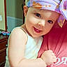 baby, child, infant, smiling, happy, portrait, headband, floral, colorful, indoor, home, hugging, adult, person, face, eyes, white_clothing, pink_shirt, dresser, shoes