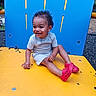 Dj .. is registered to the contest to win money with this photo: baby, bodypart, clothing, face, finger, footwear, hand, head, machine, outdoorplayarea, outdoors, person, photography, playarea, portrait, shoe, shorts, sitting, wheel, wood