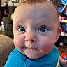 Echo is registered to the contest to win money with this photo: baby, background, blue_eyes, cheeks, child, closeup, clothing, curious_expression, cute, eyebrows, face, hand, head, indoor, infant, mouth, nose, person, shirt, skin