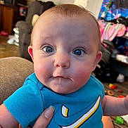 Echo joined the competition — help win amazing prizes! baby, background, blue_shirt, child, clothing, cute, expression, face, hand, holding, home, human, indoor, infant, living_room, person, seated, skin, toy, wide_eyes