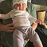 baby, infant, child, portrait, smiling, happy, hat, beanie, pom_pom, onesie, clothing, scarf, arms, hands, person, indoor, kitchen, chair, seated, family
