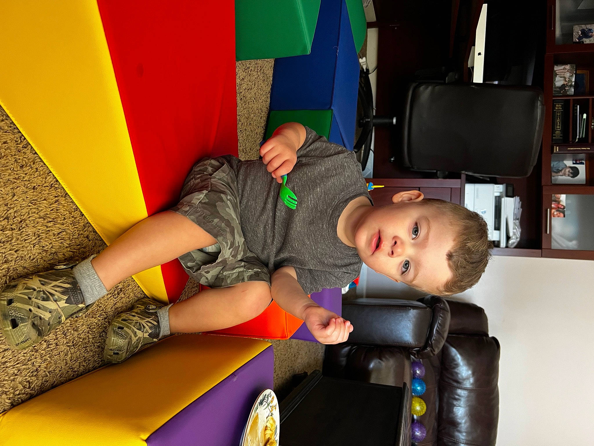 Michael joined the competition — help win amazing prizes! bookcase, child, comfort, fun, human_leg, knee, leg, leisure, luggage_and_bags, person, play, recreation, room, shelf, shorts, sitting, sock, t_shirt, thigh, toddler