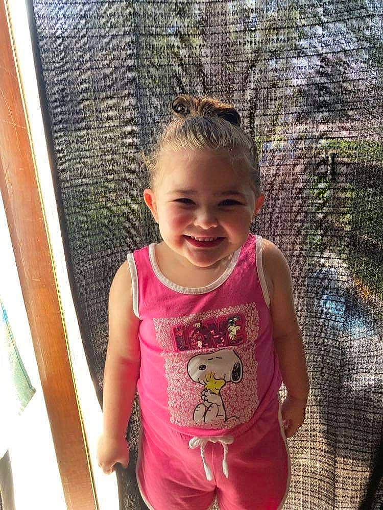 Evelyn is registered to the contest to win money with this photo: baby_toddler_clothing, child, cool, eye, face, facial_expression, fun, grass, happy, joy, leisure, mammal, mesh, mouth, person, pink, product, skin, sleeve, smile