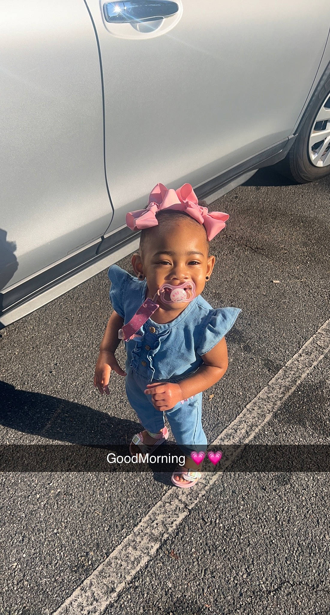 Blakeleigh is registered to the contest to win money with this photo: asphalt, auto_part, automotive_design, automotive_exterior, automotive_lighting, automotive_tire, bumper, child, happy, hat, motor_vehicle, person, public_space, road, road_surface, sidewalk, smile, tints_and_shades, tire, toddler