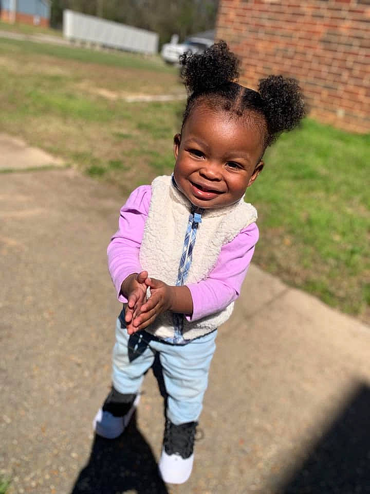 Kailey is registered to the contest to win money with this photo: baby, black_hair, child, fun, hair, hairstyle, happy, joy, people, person, pink, plant, play, recreation, shoe, smile, toddler, vacation, walking