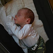 Camden joined the competition — help win amazing prizes! baby, newborn, sleeping, infant, blanket, clothing, camo_pants, white_shirt, peaceful, soft, indoors, portrait, cute, child, person, resting, cozy, young, lying_down, sleep