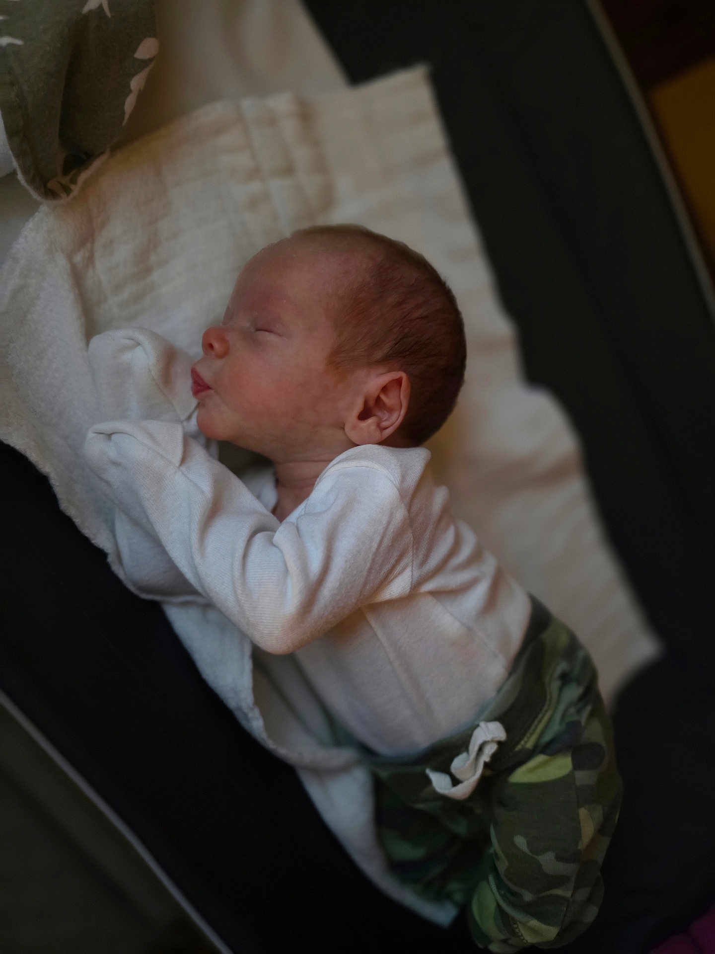 Camden joined the competition — help win amazing prizes! baby, newborn, sleeping, infant, blanket, clothing, camo_pants, white_shirt, peaceful, soft, indoors, portrait, cute, child, person, resting, cozy, young, lying_down, sleep