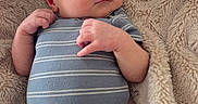Bennett is registered to the contest to win money with this photo: baby, newborn, sleeping, infant, blanket, soft_texture, clothing, striped_shirt, cozy, peaceful, cute, human, portrait, skin, hand, face, rest, comfort, lying_down, indoors