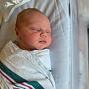 Bennett is registered to the contest to win money with this photo: newborn, baby, sleeping, swaddled, blanket, hospital, infant, face, peaceful, resting, soft_light, portrait, child, bed, wrapped, cute, tiny, human, newborn_baby, closeup