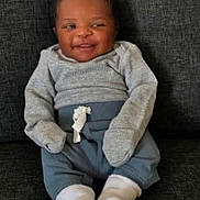 Amazi joined the competition — help win amazing prizes! baby, infant, smile, mittens, socks, sitting, couch, clothing, cozy, cute, happy, person, portrait, indoor, fabric, young_child, casual, relaxing, child, comfort
