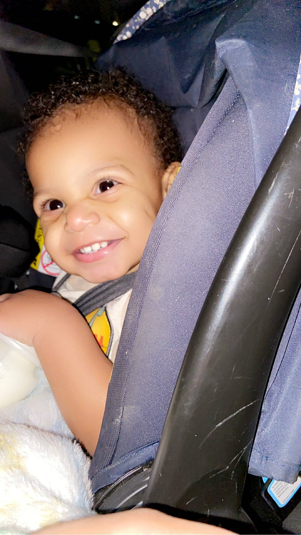 Messiah is registered to the contest to win money with this photo: auto_part, baby, baby_carriage, baby_products, baby_toddler_clothing, car_seat, car_seat_cover, child, comfort, electric_blue, facial_expression, finger, flash_photography, fun, happy, human_body, iris, joy, person, skin