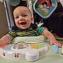baby, smiling, walker, toy, indoor, child, play, happy, face, infant, clothing, striped_shirt, furniture, colorful, hand, seat, plastic, activity_center, person, cute