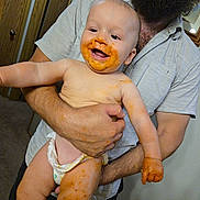Jensen is registered to the contest to win money with this photo: adult, arm, baby, beard, child, clothing, cute, diaper, face, family, food, hand, happy, holding, indoor, kitchen, mealtime, messy, person, smiling