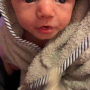 Kashdon joined the competition — help win amazing prizes! baby, child, towel, face, close_up, portrait, expression, curious, wrapped, soft_texture, striped, indoor, skin, head, young, infant, cute, person, eyes, mouth