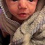 baby, child, towel, face, close_up, portrait, expression, curious, wrapped, soft_texture, striped, indoor, skin, head, young, infant, cute, person, eyes, mouth