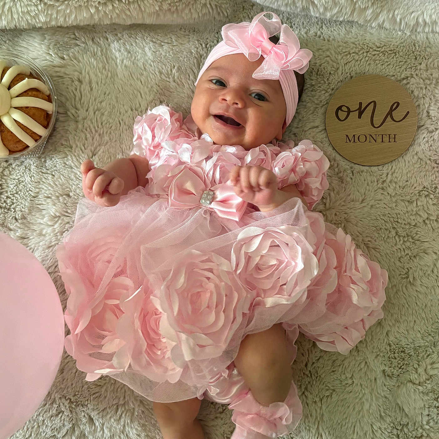 Jacyntha is registered to the contest to win money with this photo: baby, balloon, candle, celebration, child, cupcake, cute, decor, fluffy_rug, happy, headband, infant, lying_down, milestone_sign, one_month, party, pink_dress, portrait, smiling, soft_texture