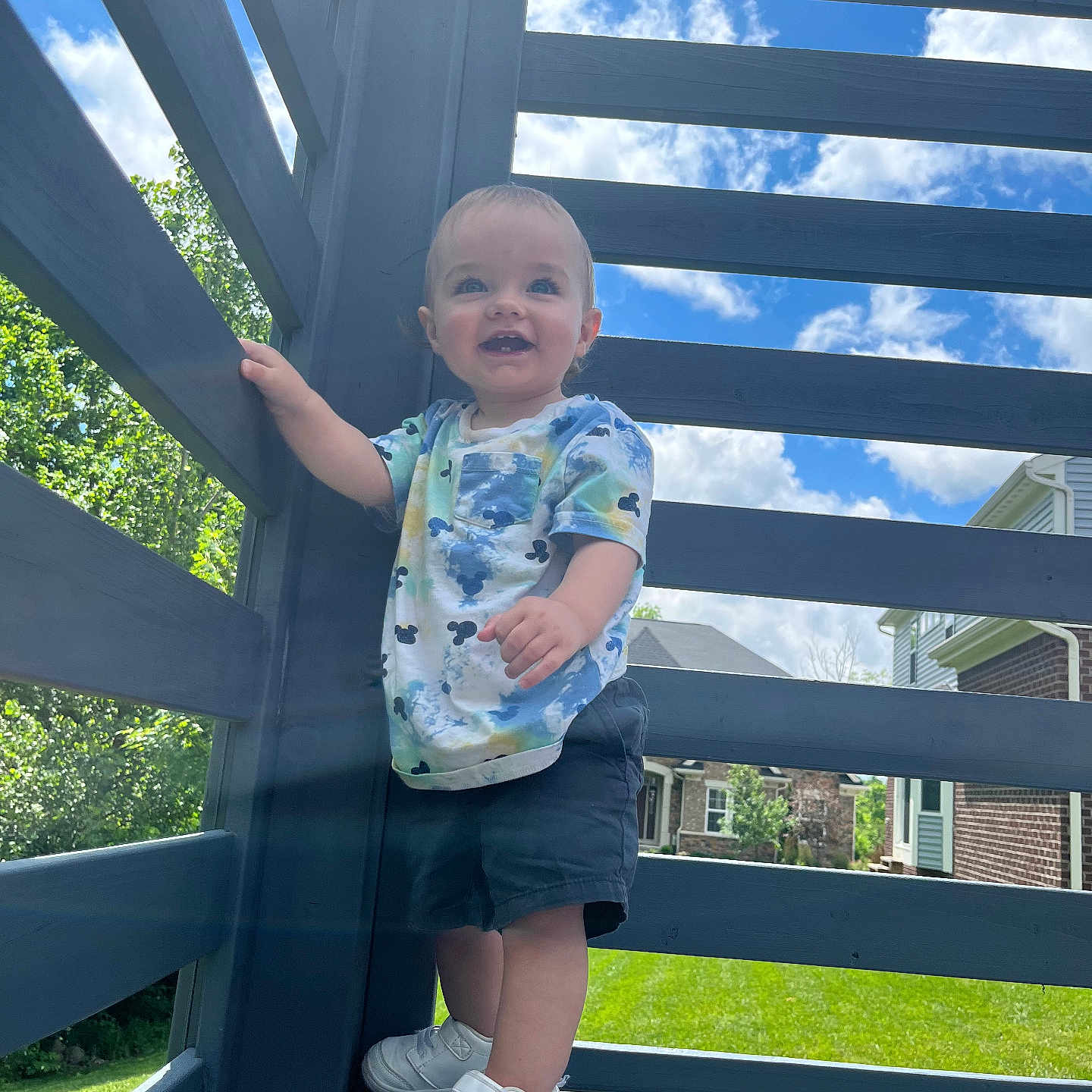 Aiden is registered to the contest to win money with this photo: architecture, boy, building, child, clothing, face, footwear, head, house, housing, male, pants, person, photography, porch, portrait, shoe, shorts, sneaker, wood