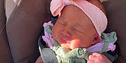 Ryverlynn Rose is registered to the contest to win money with this photo: newborn, baby, infant, car_seat, headband, pink, green_outfit, bottle, feeding, sleeping, strap, safety_harness, closeup, cute, tiny_hands, baby_clothes, indoors, soft_light, resting, adorable