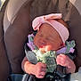 newborn, baby, infant, car_seat, headband, pink, green_outfit, bottle, feeding, sleeping, strap, safety_harness, closeup, cute, tiny_hands, baby_clothes, indoors, soft_light, resting, adorable
