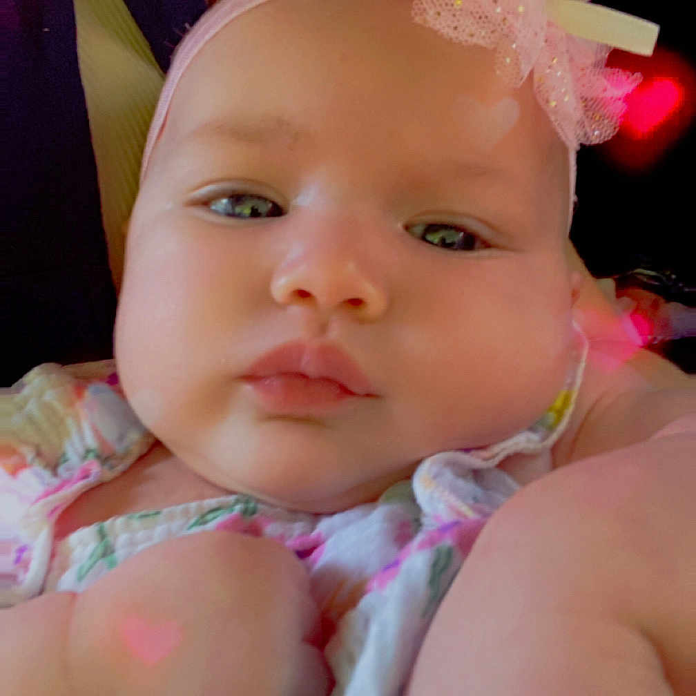 Ryverlynn Rose joined the competition — help win amazing prizes! adorable, baby, bow, child, chubby_cheeks, closeup, cute, expressionless, face, floral_clothing, hand, headband, heart_shape, indoors, infant, pink, portrait, skin, soft_lighting, young
