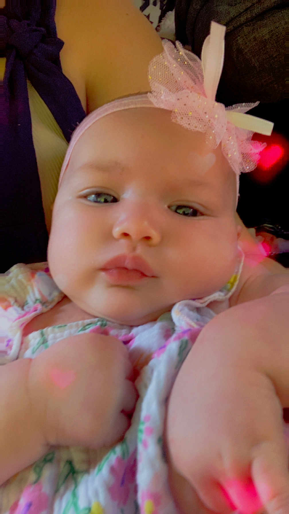 Ryverlynn Rose joined the competition — help win amazing prizes! baby, infant, face, headband, bow, pink, chubby_cheeks, closeup, cute, hand, floral_clothing, soft_lighting, heart_shape, portrait, child, adorable, skin, expressionless, young, indoors