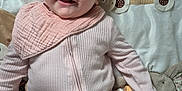 Emme joined the competition — help win amazing prizes! baby, infant, smiling, pink_onesie, bib, playmat, giraffe_toy, soft_toys, colorful_toys, lying_down, happy, face, cute, child, indoors, fabric, pattern, closeup, person, young_child