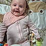 baby, infant, smiling, pink_onesie, bib, playmat, giraffe_toy, soft_toys, colorful_toys, lying_down, happy, face, cute, child, indoors, fabric, pattern, closeup, person, young_child