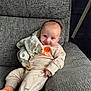 Emme joined the competition — help win amazing prizes! baby, infant, smiling, couch, gray_couch, clothing, onesie, pacifier_clip, soft_toy, blanket, indoors, cute, child, happy, portrait, relaxing, cozy, orange_socks, fabric_texture, home