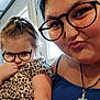 child, woman, glasses, freckles, leopard_print, dress, indoor, selfie, portrait, face, hair, skin, expression, cute, playful, digital_art, necklace, cross, window, light
