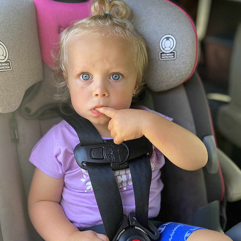 Destin is registered to the contest to win money with this photo: accessories, baby, belt, bodypart, car, car_interior, carseat, cushion, face, finger, hand, head, headrest, homedecor, person, photography, portrait, sitting, transportation, vehicle