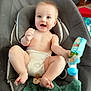 baby, diaper, smile, toy, pacifier, blanket, baby_seat, indoor, child, happy, cute, person, infant, skin, hand, foot, face, furniture, play, comfort