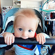 Cody joined the competition — help win amazing prizes! baby, blanket, blue_eyes, child, clothing, curly_hair, cute, fridge, hand, handlebar, home, indoor, infant, laundry, magnet, person, playful, seat, stroller, toy