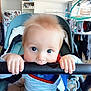 baby, blanket, blue_eyes, child, clothing, curly_hair, cute, fridge, hand, handlebar, home, indoor, infant, laundry, magnet, person, playful, seat, stroller, toy