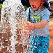 Griffin joined the competition — help win amazing prizes! child, toddler, water, splash, hat, shorts, blue, outdoor, summer, play, fun, sunlight, expression, water_spray, curiosity, person, nature, daylight, park, clothing