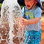child, toddler, water, splash, hat, shorts, blue, outdoor, summer, play, fun, sunlight, expression, water_spray, curiosity, person, nature, daylight, park, clothing