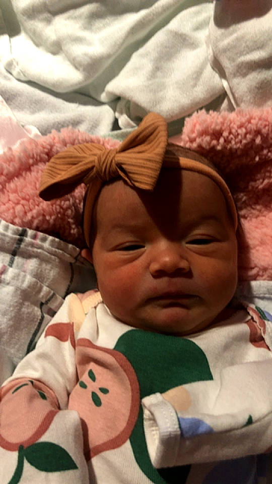 Novalynn is registered to the contest to win money with this photo: baby, cheek, chin, comfort, eyelash, facial_expression, finger, happy, head, human, human_body, mammal, mouth, nose, person, pink, product, skin, textile, vertebrate