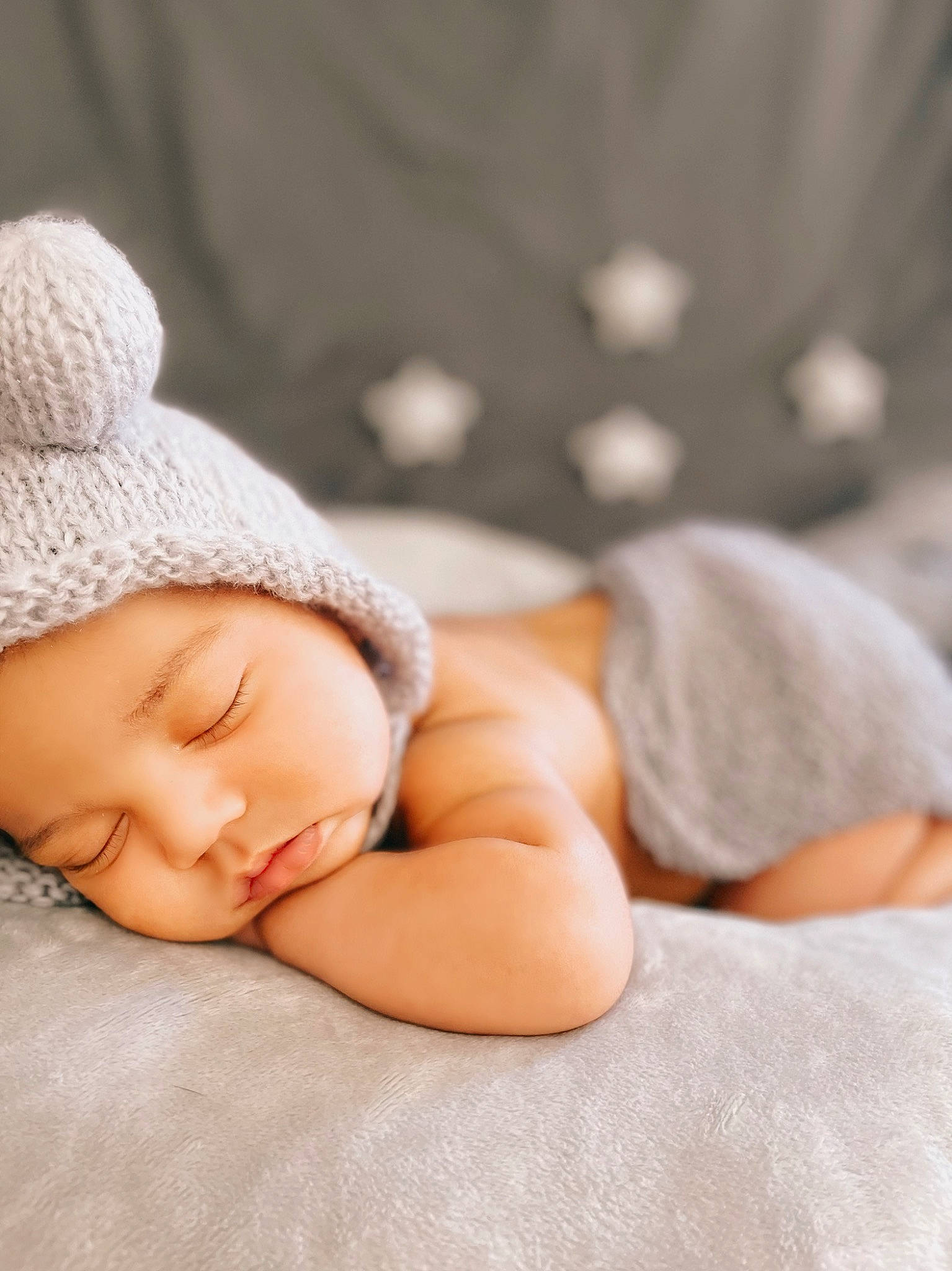 Khalil is registered to the contest to win money with this photo: baby, baby_sleeping, baby_toddler_clothing, beanie, cheek, child, comfort, fashion_accessory, flash_photography, flooring, fur, grass, headwear, knit_cap, linens, person, portrait_photography, sitting, skin, sleep