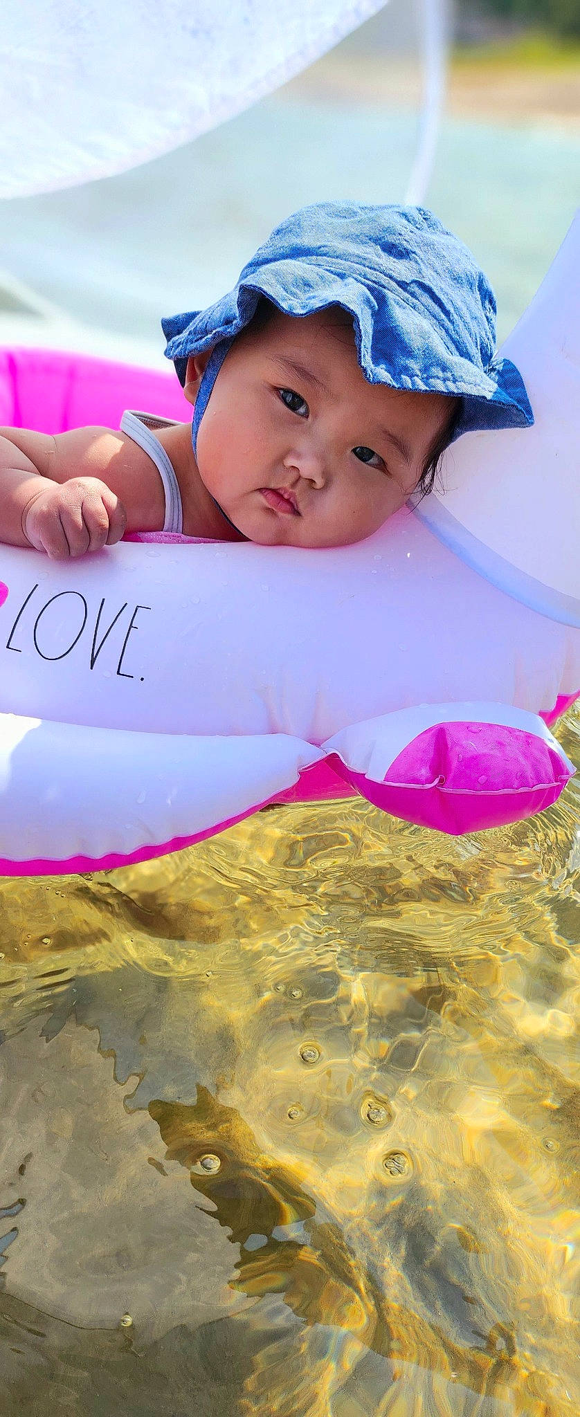 Mila is registered to the contest to win money with this photo: baby, baby_toddler_clothing, beauty, blue, cap, child, cool, face, facial_expression, grass, handwriting, happy, hat, headwear, leisure, people_in_nature, person, pink, recreation, sun_hat