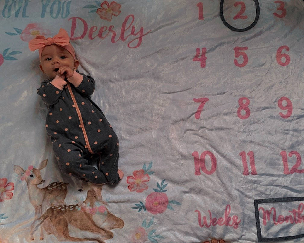 Everleigh is registered to the contest to win money with this photo: art, baby_toddler_clothing, child, flooring, font, handwriting, headwear, linens, magenta, paper, pattern, person, pink, room, sleeve, t_shirt, teddy_bear, textile, toddler, visual_arts