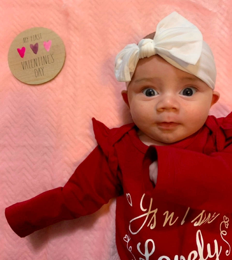 Everleigh joined the competition — help win amazing prizes! baby, baby_toddler_clothing, cap, carmine, cheek, child, costume_hat, face, fashion_accessory, font, fur, happy, headwear, linens, magenta, outerwear, peach, person, pink, skin