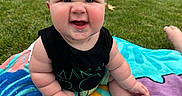 Daxton is registered to the contest to win money with this photo: baby, child, outdoor, grass, towel, funny_face, sitting, cute, blond_hair, expression, skin, foot, hand, vehicle, car, house, lawn, summer, playtime, casual_clothing