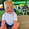 Daxton joined the competition — help win amazing prizes! baby, child, toddler, smiling, drooling, outdoor, picnic_table, green_tent, grass, people, plastic_chair, sunny, daylight, face, happy, sitting, shorts, white_shirt, blue_eyes, hair